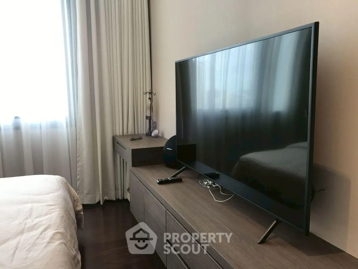 Modern bedroom with sleek TV and stylish furniture