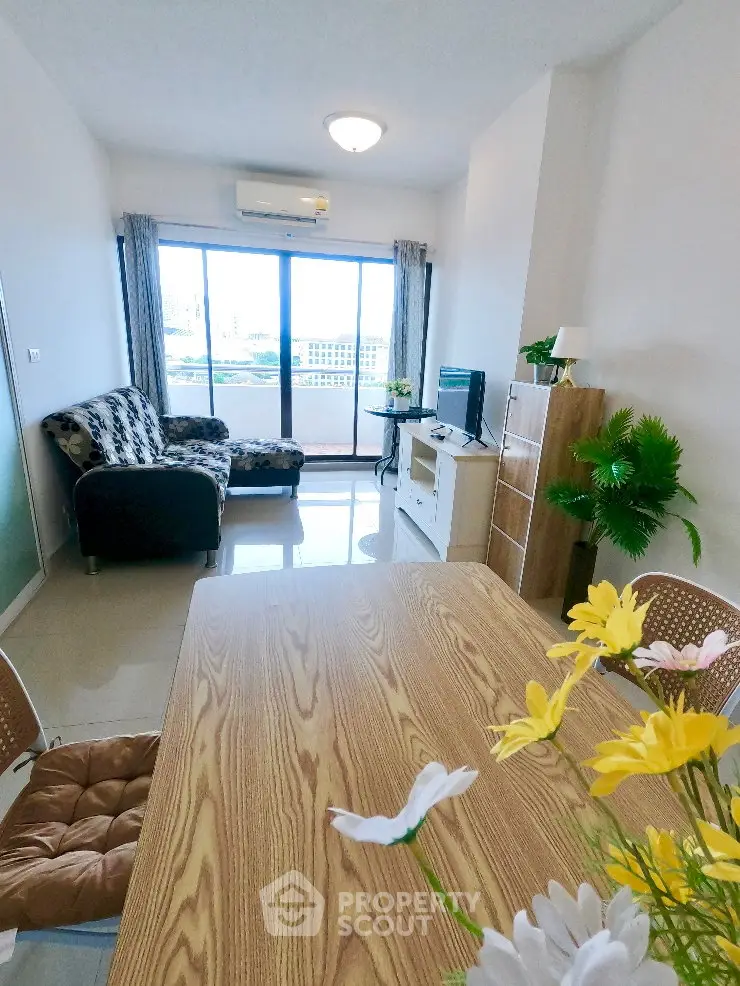 Bright living room with modern decor and large windows offering a stunning view.