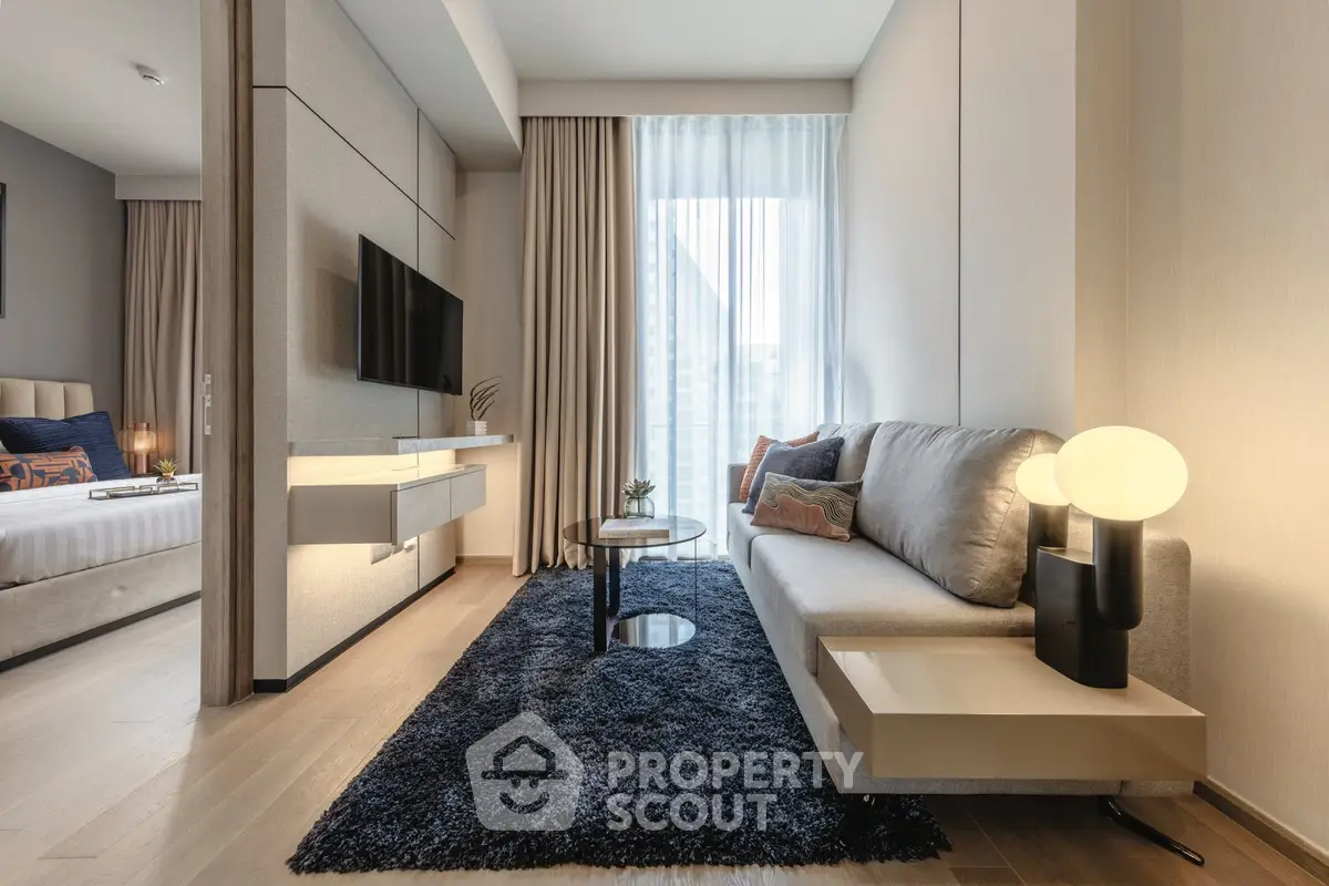 Modern living room with sleek design and cozy ambiance, featuring a plush sofa and stylish decor.