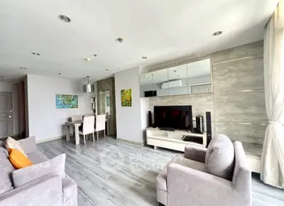 Spacious modern living room with elegant decor and ample natural light, perfect for relaxation and entertainment.