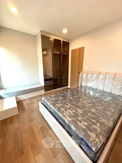 Modern bedroom with wooden flooring and stylish wardrobe