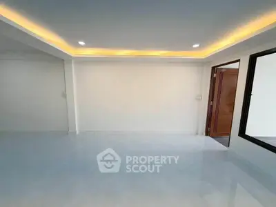 Spacious modern living room with recessed lighting and open layout