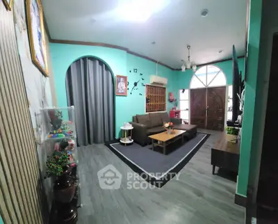 Charming living room with modern decor, cozy seating, and elegant lighting, perfect for relaxation and entertaining.