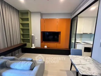 Modern living room with stylish furniture and open kitchen layout in a contemporary apartment.