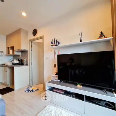 Modern living room with open kitchen and stylish decor in a cozy apartment.