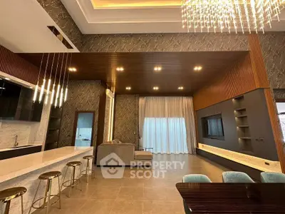 Luxurious modern living room with elegant lighting and open kitchen layout