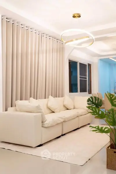 Elegant living room with plush white sofa and modern lighting