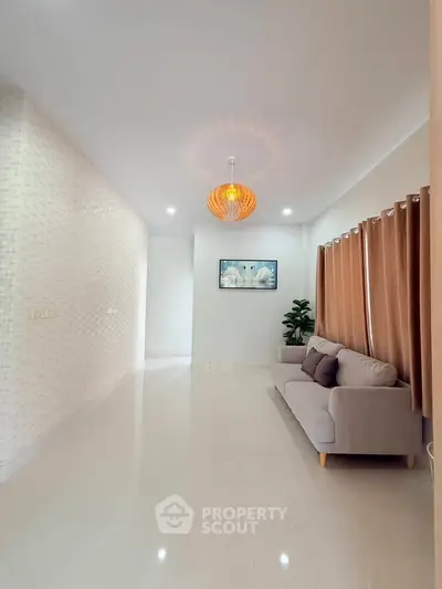 Spacious modern living room with elegant lighting and cozy sofa
