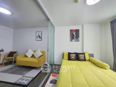 Modern living room with vibrant yellow furniture and stylish decor