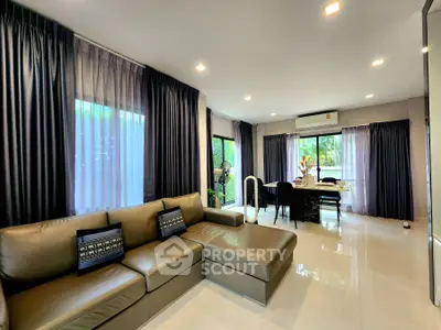 Spacious modern living room with large windows and elegant dining area