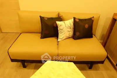 Cozy living room with modern beige sofa and decorative pillows