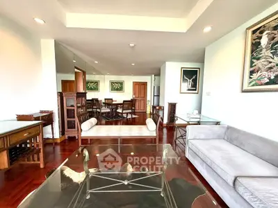 Spacious living room with elegant decor and hardwood floors in a modern apartment.