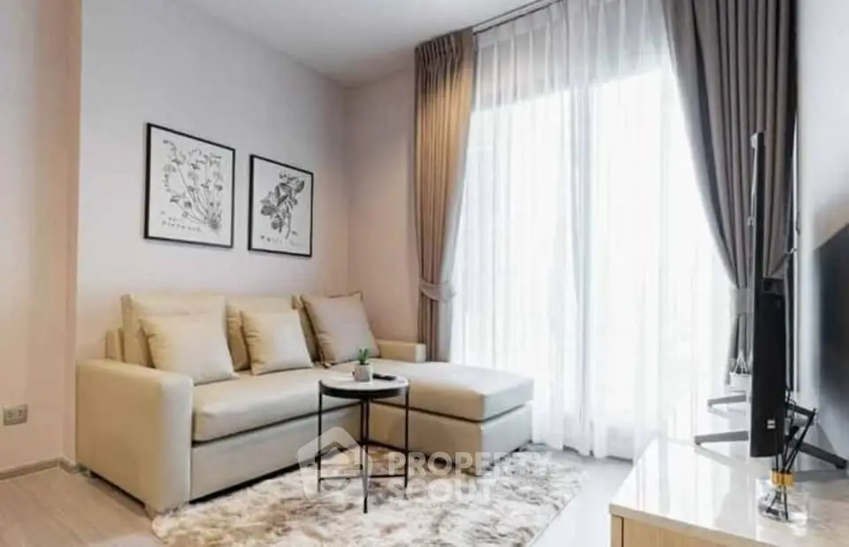 Modern living room with cozy sofa, stylish decor, and natural light through large windows.