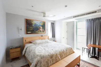 Spacious bedroom with modern decor and natural light