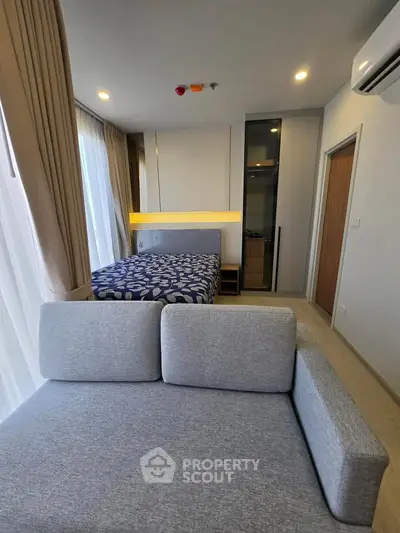 Modern studio apartment with cozy living area and stylish bedroom