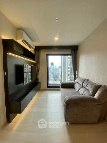 Modern living room with city view, sleek furniture, and natural light.