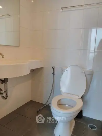 Modern bathroom with white tiles and sleek fixtures in a contemporary home.