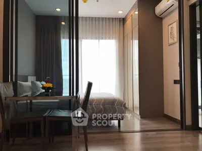 Modern bedroom with glass partition and cozy dining area in stylish apartment