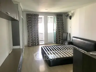 Spacious bedroom with modern furnishings and balcony access