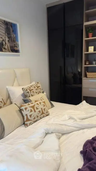 Cozy bedroom with stylish decor and modern storage solutions, perfect for urban living.