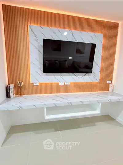 Modern living room with stylish TV wall and marble accents