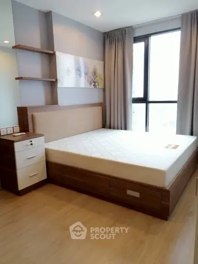 Modern bedroom with large window and stylish wooden furniture in a high-rise apartment.