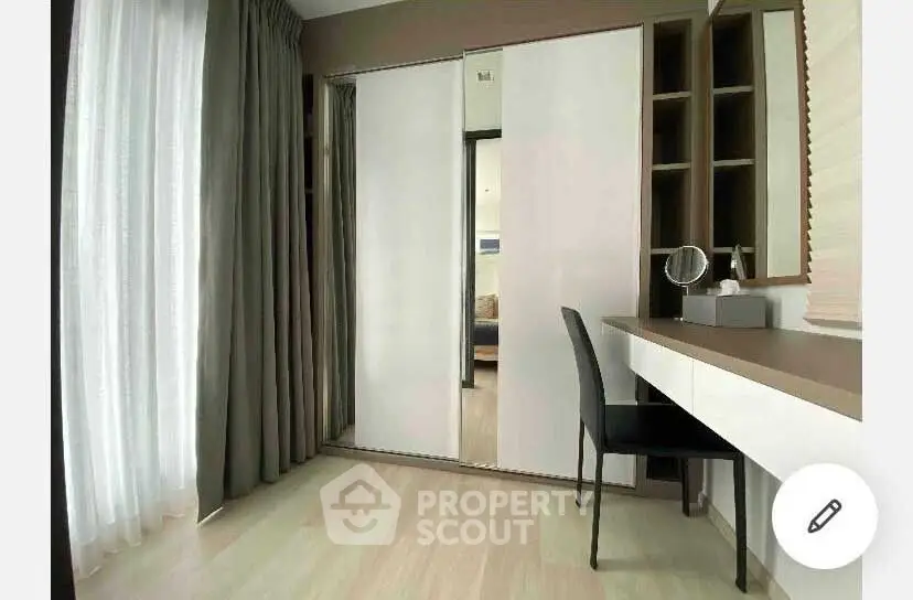 Modern bedroom with sleek design, featuring a built-in wardrobe and stylish vanity desk.