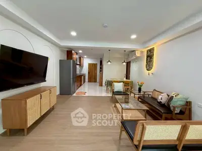 Stylish open-plan living room with modern kitchen and elegant decor