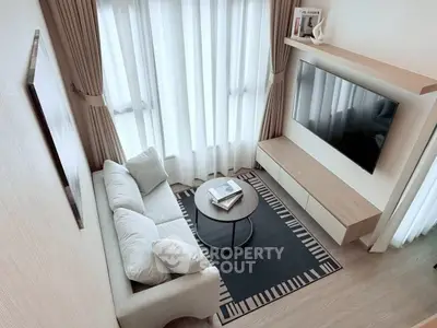 Modern living room with cozy sofa, wall-mounted TV, and stylish decor