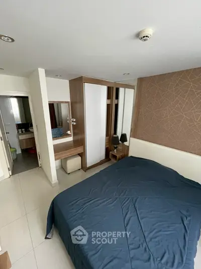 Modern bedroom with stylish wardrobe and cozy bed in a contemporary apartment.
