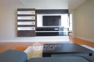 Modern living room with sleek entertainment unit and hardwood floors