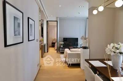 Modern living room with elegant decor and open layout, featuring cozy seating and stylish lighting.