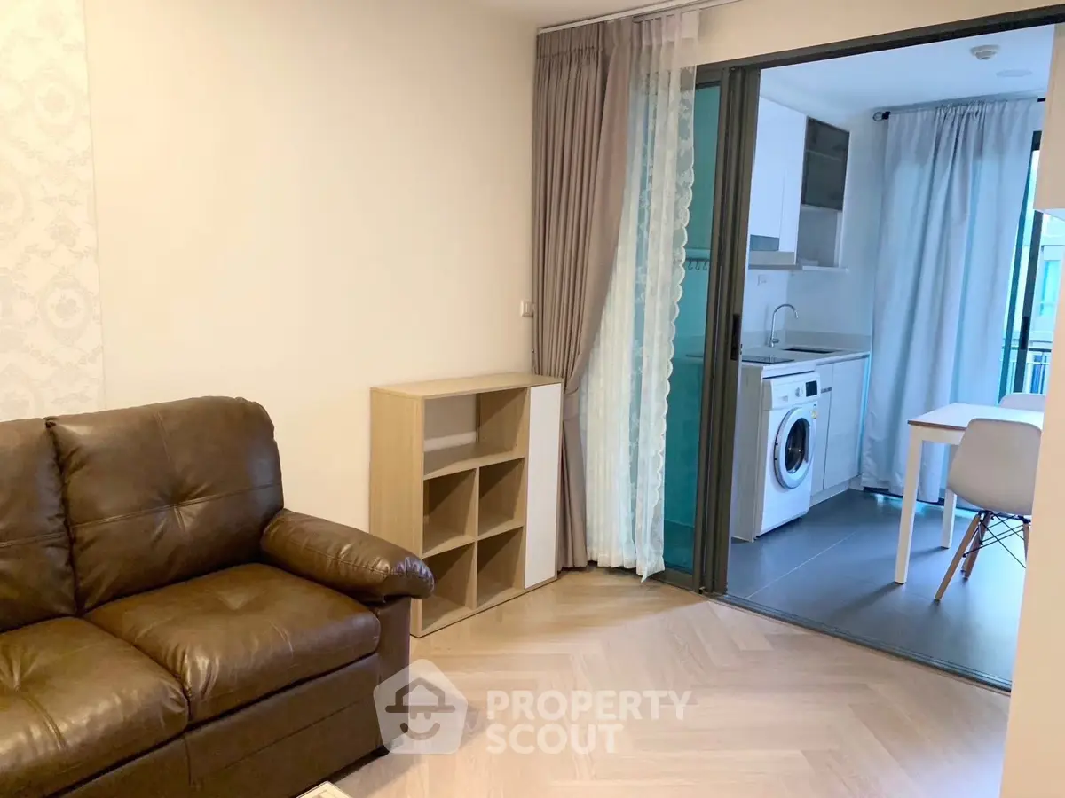 Modern living room with sliding glass door to kitchen and washing machine
