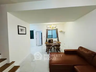 Spacious living room with modern furniture and elegant dining area, perfect for family gatherings.