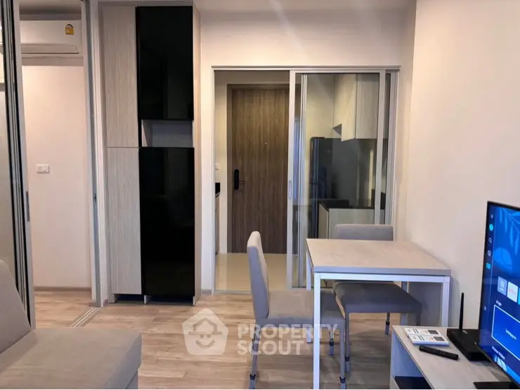 Modern living room with sleek furniture and sliding glass door, perfect for urban living.