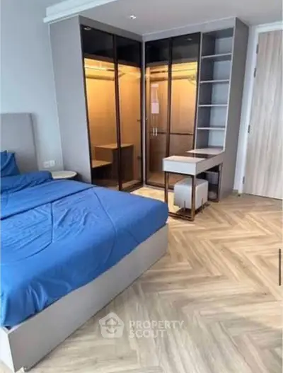 Modern bedroom with stylish walk-in closet and elegant parquet flooring