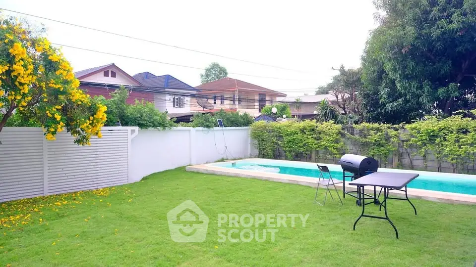 Spacious backyard with pool and BBQ area in suburban home