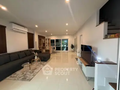Spacious modern living room with sleek furniture and large windows