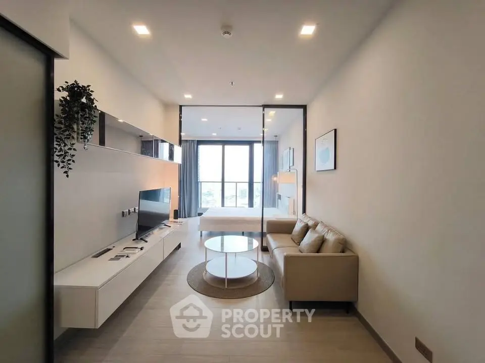 Modern living room with sleek design and large windows offering natural light.