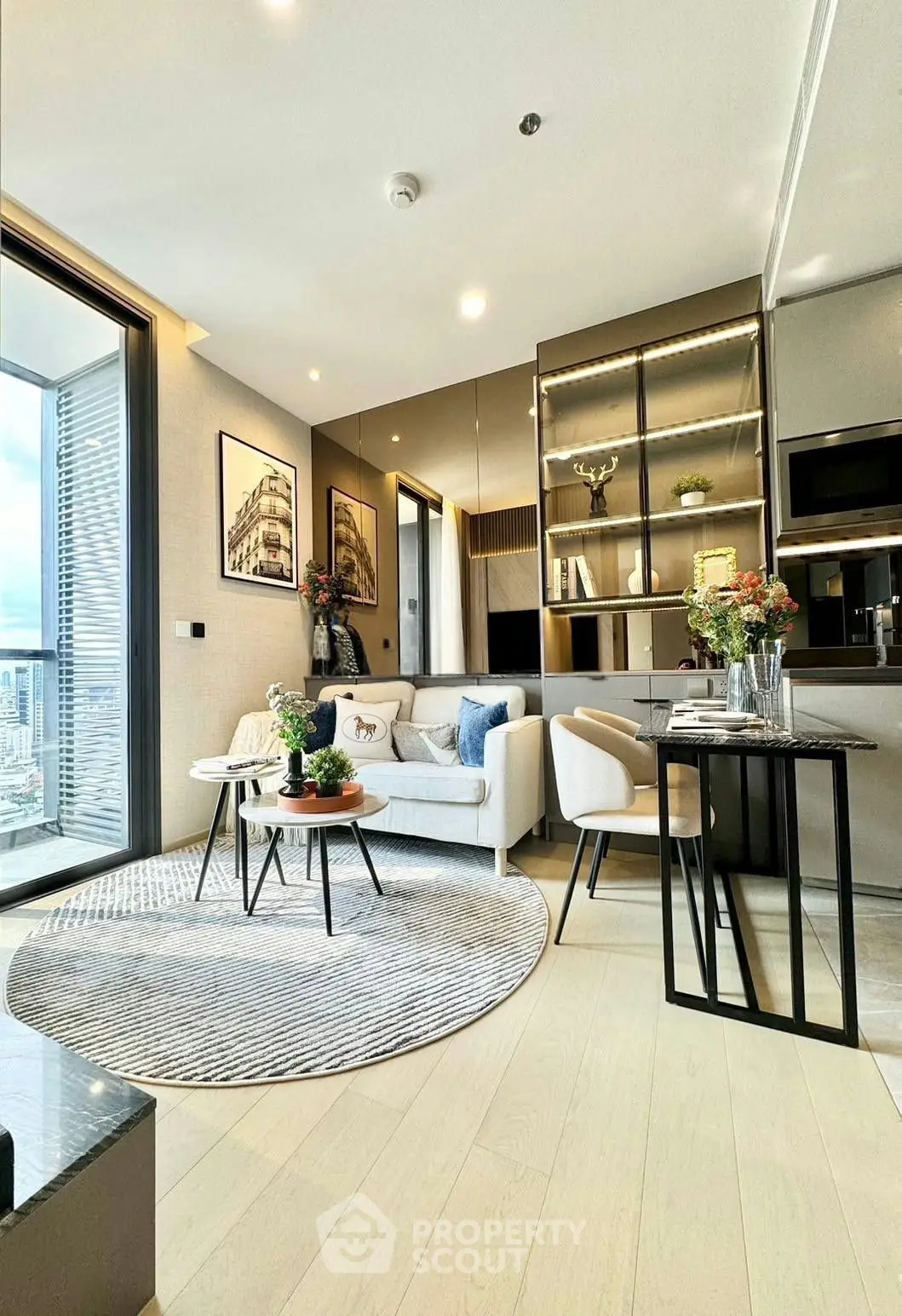 Modern living room with open kitchen and balcony view in luxury apartment