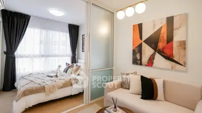 Modern bedroom with stylish decor and cozy living area in open layout apartment.