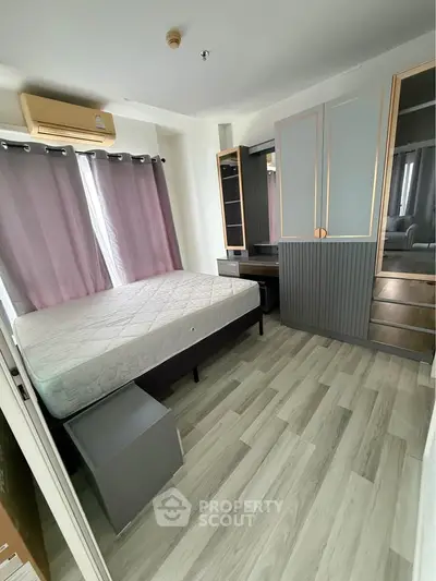 Modern bedroom with stylish wardrobe and large window for natural light