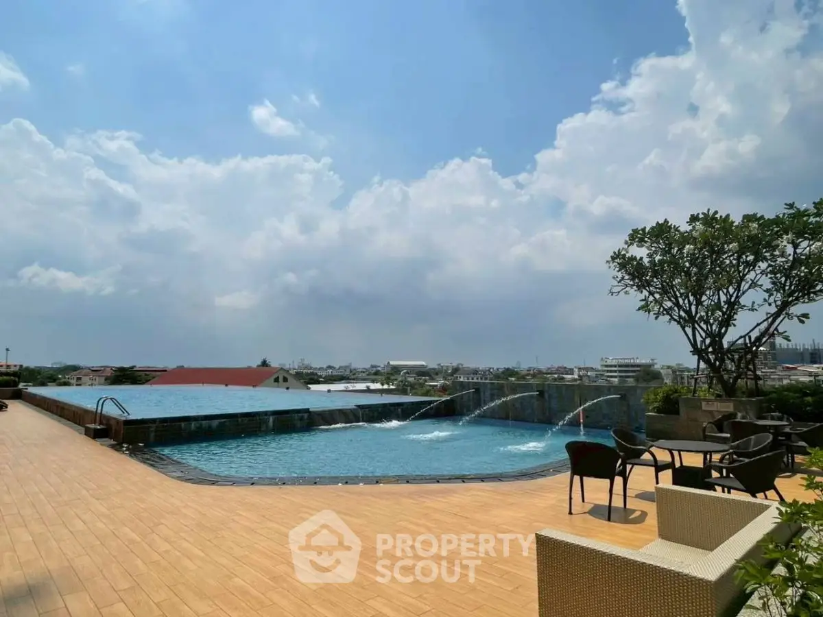 Luxurious rooftop pool with stunning city views and elegant seating area.