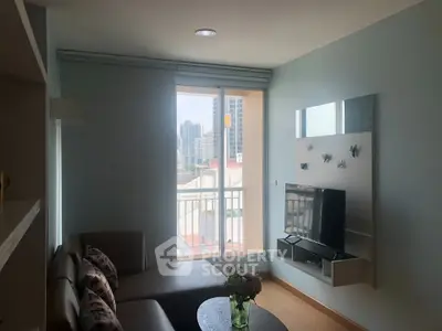 Modern living room with city view, featuring sleek furniture and a wall-mounted TV, perfect for urban living.