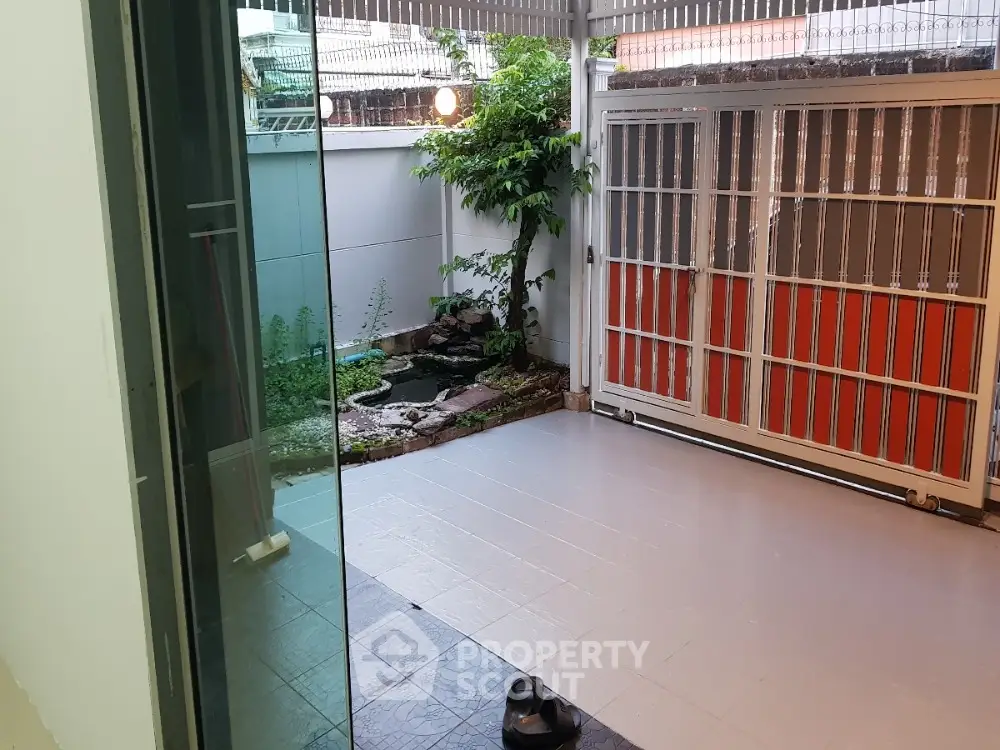 Charming patio with garden view and sliding glass doors