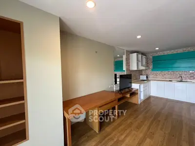 Spacious open-plan living area with modern kitchen and wooden flooring