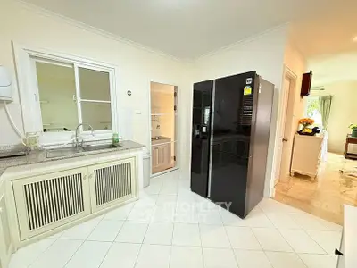 Spacious kitchen with modern appliances and open layout, perfect for culinary enthusiasts.