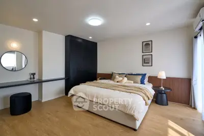 Spacious modern bedroom with elegant decor and natural light