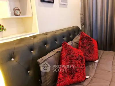 Luxurious bedroom with plush red pillows and elegant tufted headboard, perfect for relaxation.