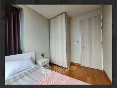 Modern bedroom with wooden flooring and minimalist decor